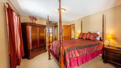 a bedroom with a bed and a dresser and a bed sidx sidx sidx sidx at Trails Edge #03 By Bear Country in Sun Peaks