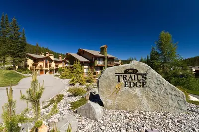 a large rock with the words sun trails bbc on it at Trails Edge #25 By Bear Country in Sun Peaks
