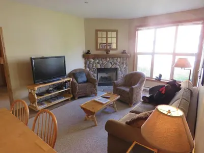 a living room with a couch and a fireplace at Crystal Forest #63 By Bear Country in Sun Peaks