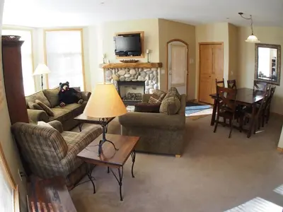 a living room with two couches and a fireplace at Crystal Forest #60 By Bear Country in Sun Peaks