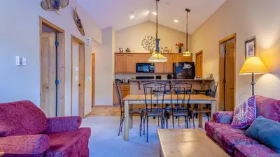 a living room with a couch and a table at Crystal Forest #54 By Bear Country in Sun Peaks