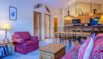 a living room with a couch and a table at Crystal Forest #54 By Bear Country in Sun Peaks