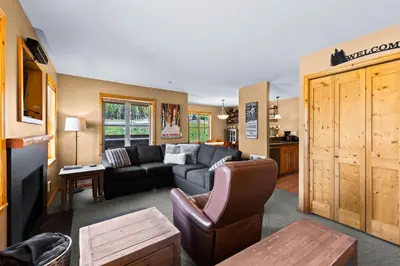 a living room with a couch and a table at Crystal Forest #22 By Bear Country in Sun Peaks