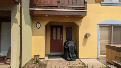 a backpack leaning against the door of a house at Crystal Forest #04 By Bear Country in Sun Peaks
