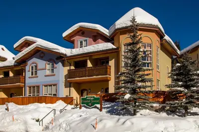a house in the snow with a sign in front of it at Crystal Forest #04 By Bear Country in Sun Peaks