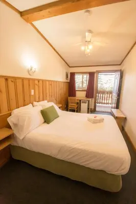a bedroom with a large white bed in a room at Gateway Motel in Radium Hot Springs