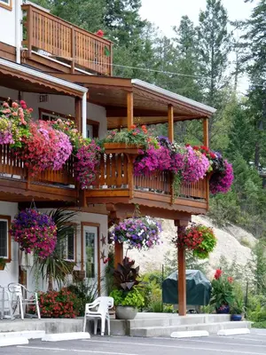 a building with lots of flowers on a balcony at Gateway Motel in Radium Hot Springs