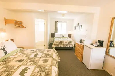 a hotel room with two beds in a room at Mountain Springs Motel in Radium Hot Springs