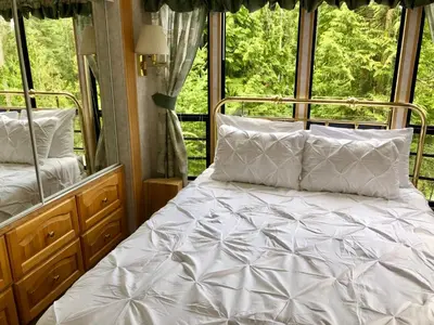 a bed in a room with a window at Garden Bay Hideaway - Glamping & RV in Garden Bay