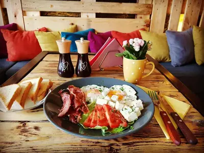 a table with a plate of food on a table at Rodee Homestay in West Kelowna