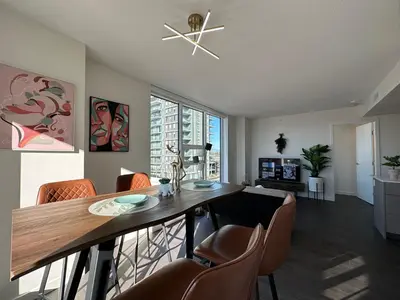 a living room with a dining room table and chairs at Gorgeous Place In Downtown RMD in Richmond