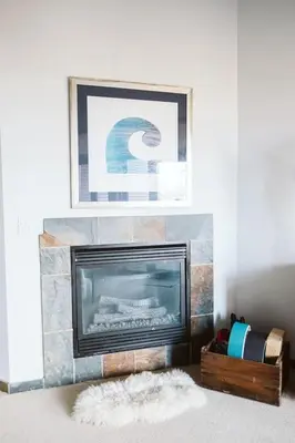 a fireplace in a living room with a fire place at Pacific Soul Eco-Luxe Vacation Home in Ucluelet