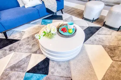 a coffee table with a plate of food on it in a living room at Nomad by Samsara Resort - Panorama Top View - 4BR & 5BTH in Canmore