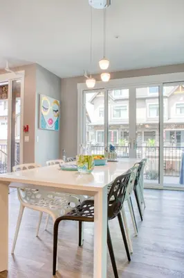 a dining room with a large white table and chairs at Nomad by Samsara Resort - Panorama Top View - 4BR & 5BTH in Canmore