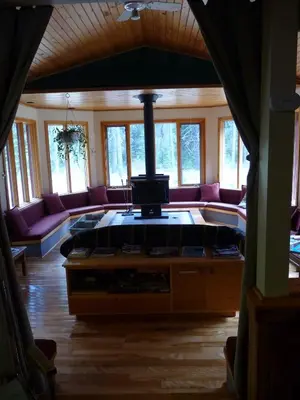 a living room with a couch and a stove at HI Castle Mountain - Hostel in Castle Junction