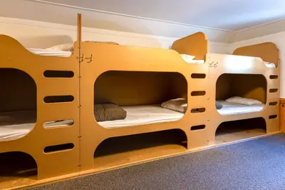 a room with two bunk beds in a room at HI Castle Mountain - Hostel in Castle Junction