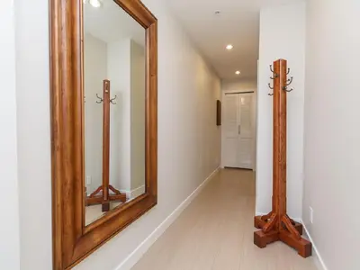 a hallway with a large mirror and a wooden frame at City Centre in Victoria