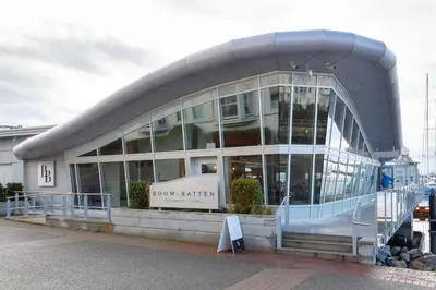 a large glass building with a sign in front of it at Deluxe 2 Bed 2 Bath With Harbour And Empress Hotel Views in Victoria