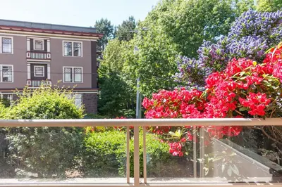 a bunch of flowers sitting on a balcony at 5 Min Walk To Famous Victoria Inner Harbour And Empress Hotel in Victoria