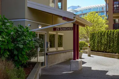 a building with a sign that reads surprise at Deluxe 2 Bed 2 Bath And 5 Min Walk To Downtown And Seawalk in Victoria