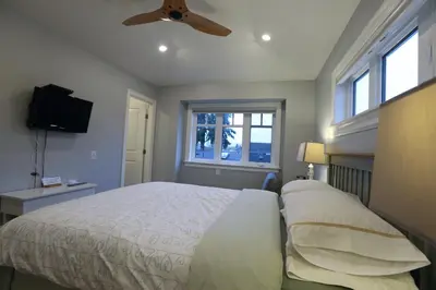 a bedroom with a bed and a ceiling fan at Vancouver Traveller B&B in Vancouver