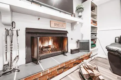a fireplace in a living room with a fire place at Along River Ridge in Calgary