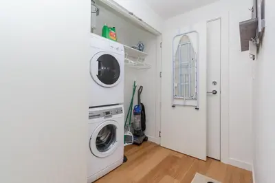 a white laundry room with a washer and dryer at Enjoy The Waterway Action At Your Doorstep in Victoria