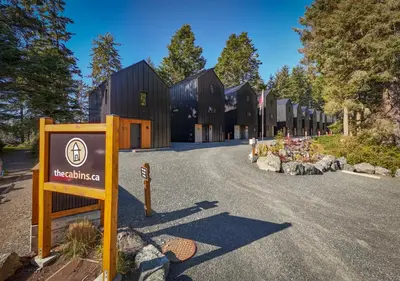 a building with a sign in the middle of a road at The Cabins at Terrace Beach in Ucluelet