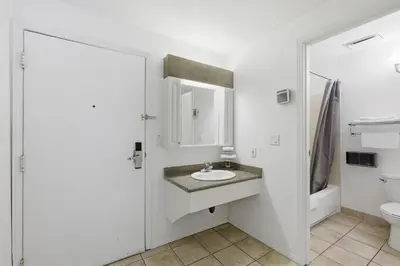 a bathroom with a sink and a toilet at Lillooet Hotel Victoria in Lillooet