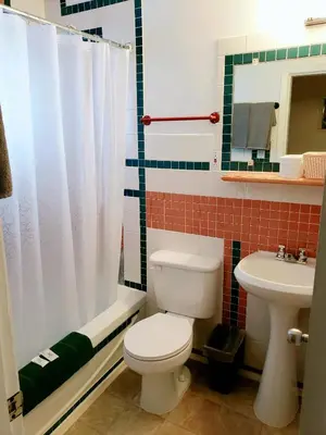 a bathroom with a toilet and a sink at Vista Motel in Vegreville