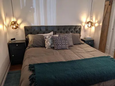 a bedroom with a large bed with pillows on it at Oceanspray Hideaway in North Saanich