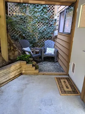 two chairs sitting on the porch of a house at Oceanspray Hideaway in North Saanich