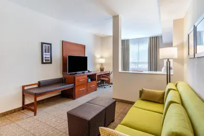 a living room with a couch and a desk with a television at Comfort Inn & Suites in Valemount