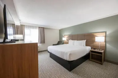 a hotel room with a bed and a flat screen tv at Quality Inn & Suites in Whitehorse