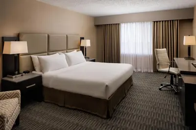 a hotel room with a large bed and a desk at Pomeroy Hotel & Conference Centre in Grande Prairie