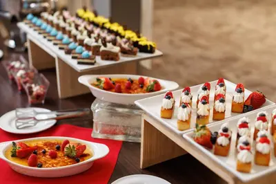a table with several plates of desserts and bowls of food at Pomeroy Hotel & Conference Centre in Grande Prairie