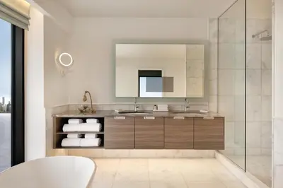 a bathroom with a sink and a mirror at Seaside Hotel North Vancouver in North Vancouver