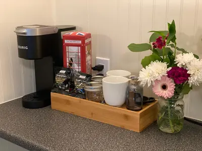 a wooden tray with a vase of flowers on a counter at Dawson Lodge in Dawson City