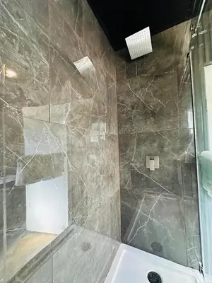 a bathroom with a shower with a tub and a sink at Sage Hills Motel in Cache Creek