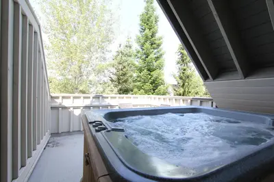 a jacuzzi tub in the backyard of a house at Lagoons Condos by Whistler Retreats in Whistler