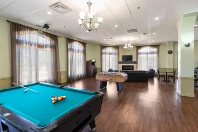 a pool table in a living room with a bill at Quality Inn & Suites in Whitecourt