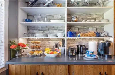 a kitchen with a counter with food on it at The Blue House Bed and Breakfast in Lake Country