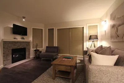 a living room with a couch and a fireplace at Glacier's Reach by Whistler Retreats in Whistler