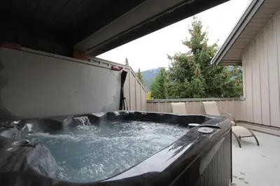 a hot tub on the back of a house at Glacier's Reach by Whistler Retreats in Whistler