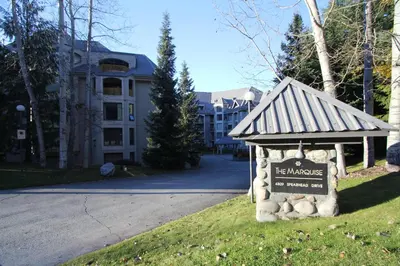 a sign in the grass in front of a building at Marquise Condos by Whistler Retreats in Whistler