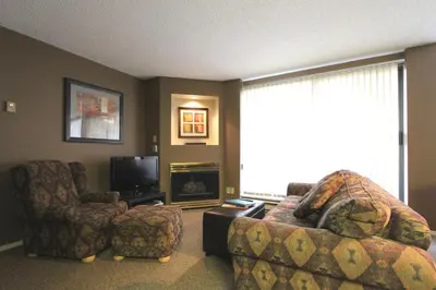 a living room with a couch and a chair and a television at Marquise Condos by Whistler Retreats in Whistler