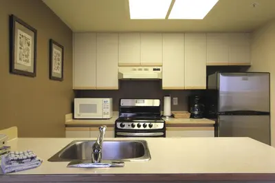 a kitchen with a sink and a refrigerator at Marquise Condos by Whistler Retreats in Whistler