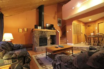 a living room with a couch and a fireplace at Rainbow Suites by Whistler Retreats in Whistler