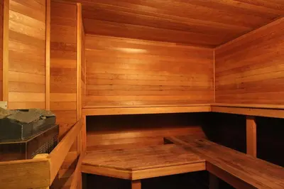 a wooden sauna with a wooden bench in it at Rainbow Suites by Whistler Retreats in Whistler