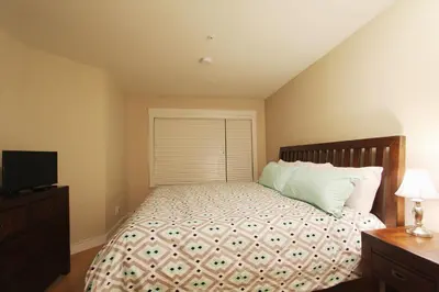 a bedroom with a bed and a television in it at Villas Snowberry by Whistler Retreats in Whistler